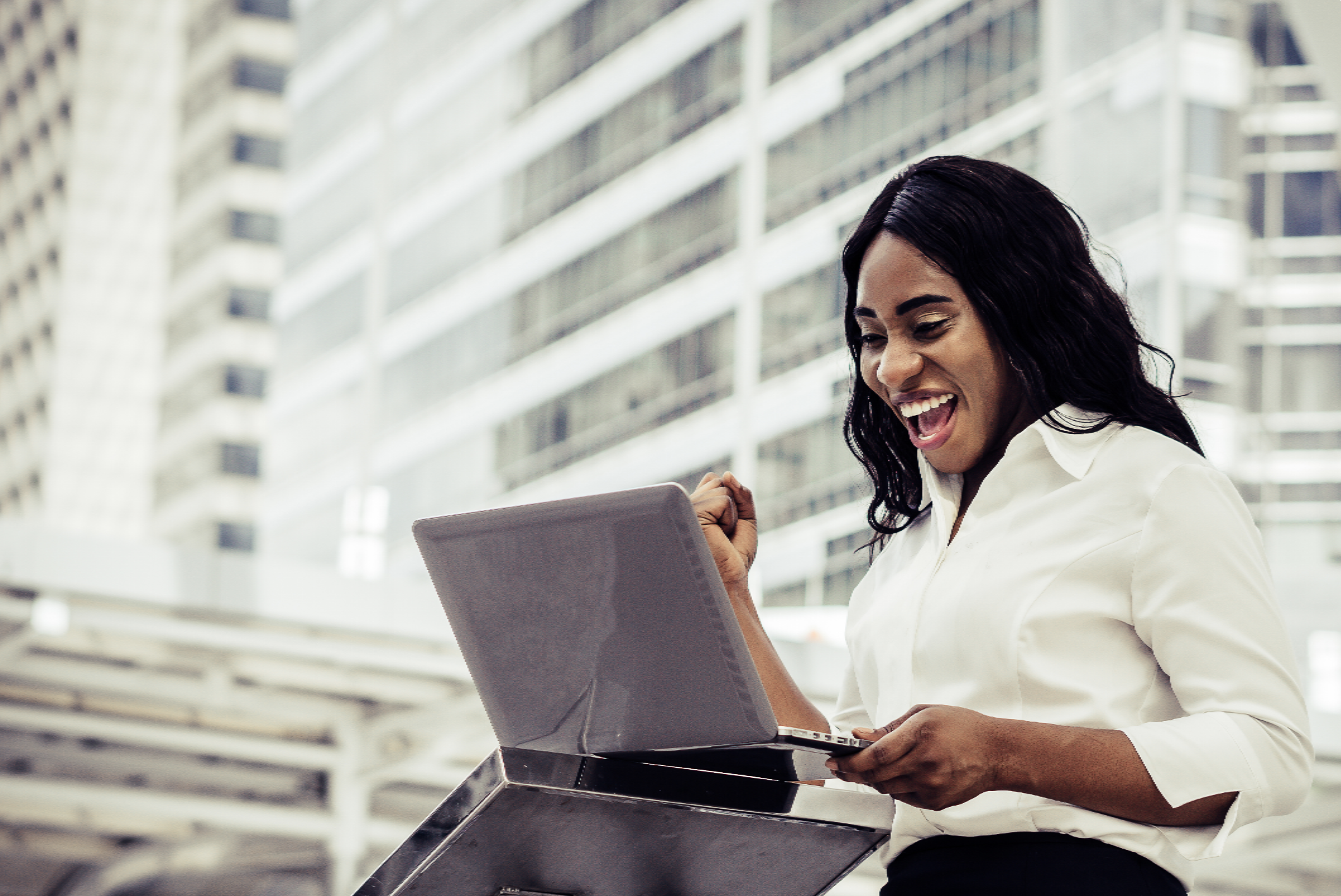 Happy professional using laptop